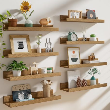 Modular floating wall shelves displaying books and decor in a Scandinavian-style home office, maximizing vertical space.
